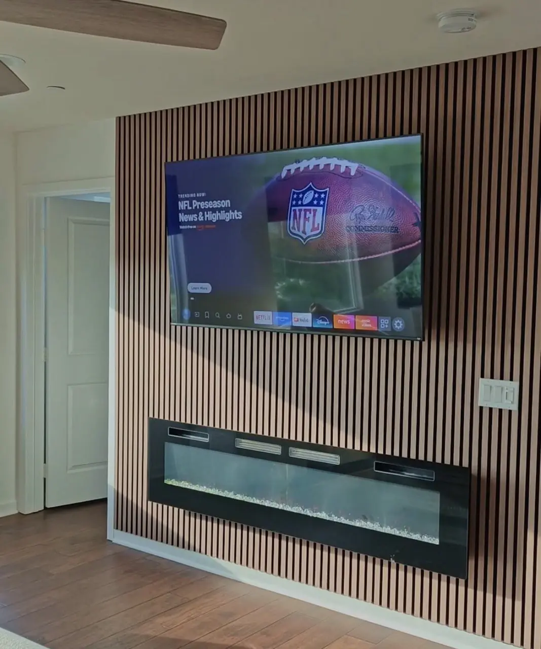 Wood slat wall NFL TV fireplace Morrisville NC